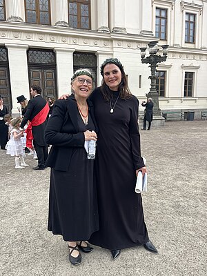 Kransprydda hedersdoktorer framför universitetshuset. Foto.
