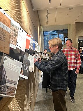 Simon Halberg spikar sin avhandling på spikbrädan. Foto.